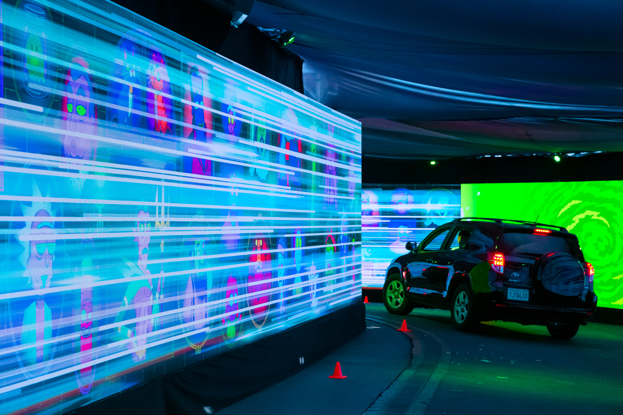 Car driving through "Morty's" LED drive-thru